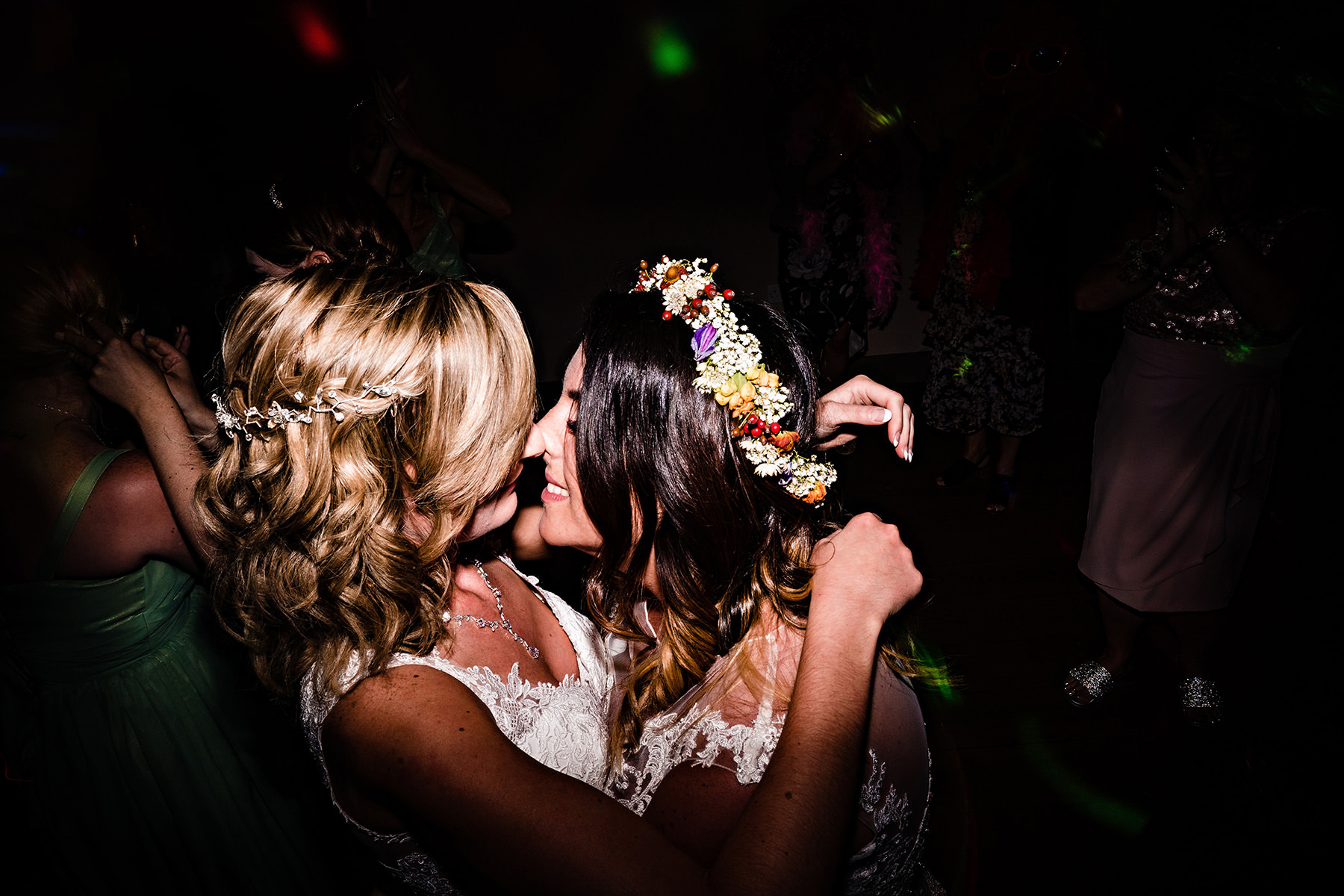 The brides in a loving embrace at a same sex wedding