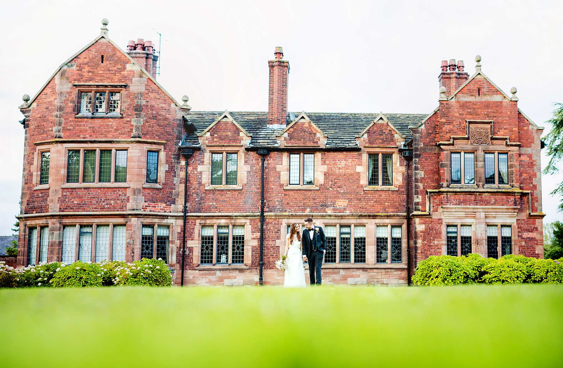 bride and groom walking outside at a wedding at Colshaw Hall, Cheshire